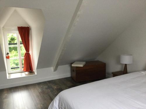 a bedroom with a bed and a window at LA MABONNAIS in Pleurtuit