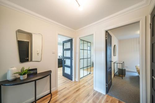 a living room with a hallway with a mirror at At The Castle in Broughty Ferry