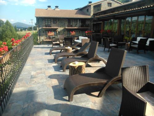 a row of chairs and tables on a patio at Hotel & SPA Peña Montañesa in Aínsa