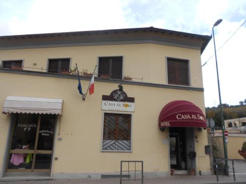 a building with a clock on the front of it at Albergo Casa Al Sole in Greve in Chianti