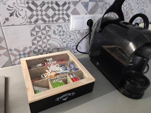 a black toaster and a box on a counter at Stafétaház Apartmanok in Vác