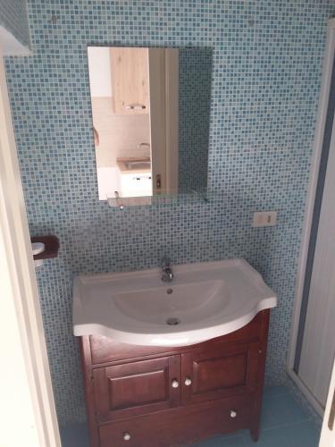 a bathroom with a sink and a mirror at Independence house 71 in Bari