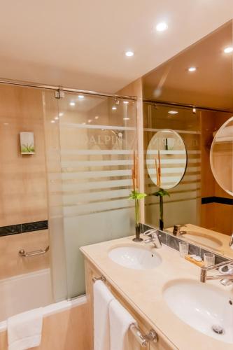 a bathroom with a sink and a shower at Guadalpin Suites in Marbella