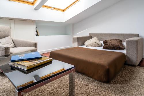 a bedroom with a bed and a couch and a table at Hotel Apolonia Soria in Soria