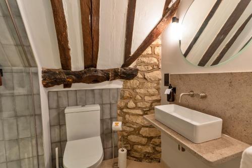 a bathroom with a toilet and a sink and a mirror at Finest Retreats - The Half-ARC of Painswick in Painswick