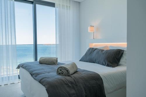 a bedroom with a bed and a large window at Shantivillas Portimão in Portimão