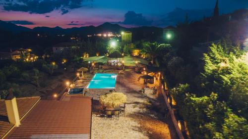 an overhead view of a swimming pool at night at Traditional house Alexis Coco with pool and fire place in Tríkorfon
