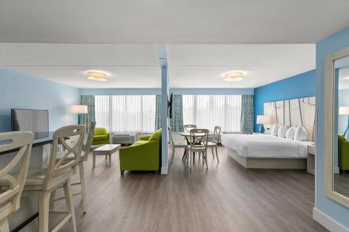 a hotel room with a bed and a table and chairs at Fenwick Inn in Ocean City