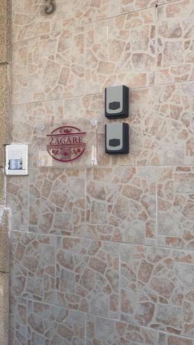a stone wall with a sign on a building at Le zagare in Palagiano