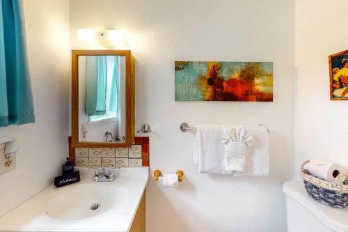 a white bathroom with a sink and a mirror at Kathryn Place Casita in Santa Fe