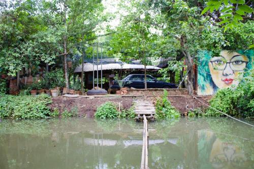 a body of water with a mural of a woman at Saigon Garden Homestay in Ho Chi Minh City