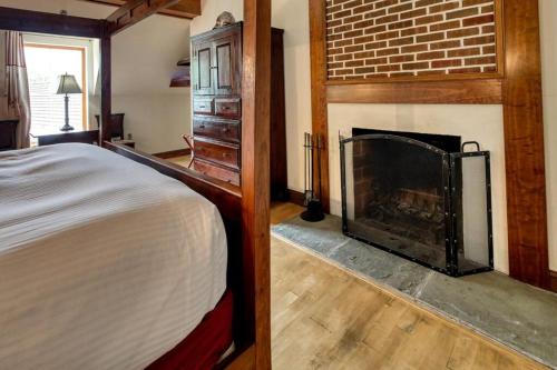a bedroom with a bed and a fireplace at Wedmore Place in Williamsburg
