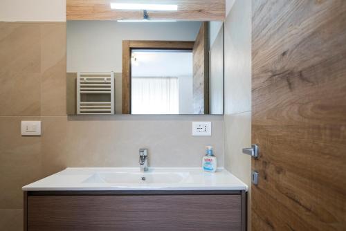 a bathroom with a sink and a mirror at Cauriol Suites 2.3 in Cavalese