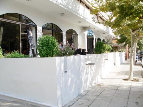 a white fence in front of a building at Aegeon Hotel - Adults Only in Kos