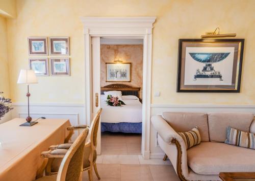 a hotel room with a bed and a couch at Guadalpin Suites in Marbella