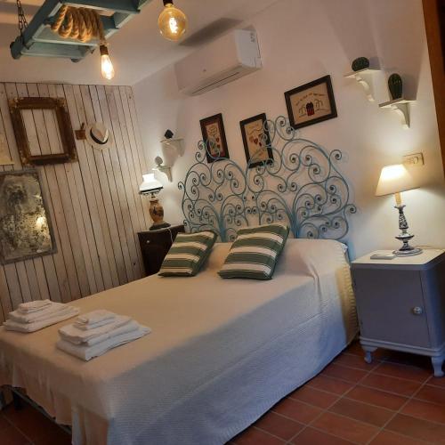 a bedroom with a large bed with a large headboard at TRULLO PIETRAPOESIA in Ostuni