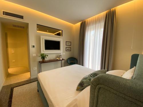 a hotel room with a bed and a couch at NoOne Tropea Guesthouse in Tropea