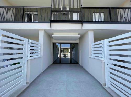 a hallway of a house with white doors and a balcony at Lecce Parkside Apartment in Lecce