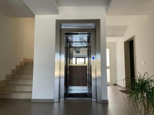 an elevator in a building with a staircase at Lecce Parkside Apartment in Lecce