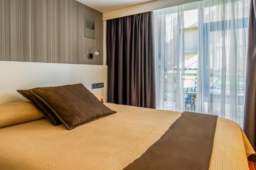 Postel nebo postele na pokoji v ubytování Hotel Apolonia Soria