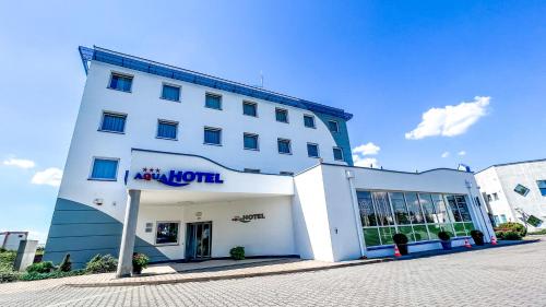 a large white building with a large window at Aqua Hotel in Polkowice