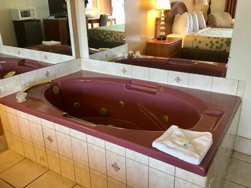 a bathroom with a bath tub in a hotel room at SilverStone Lite in Sunnyside