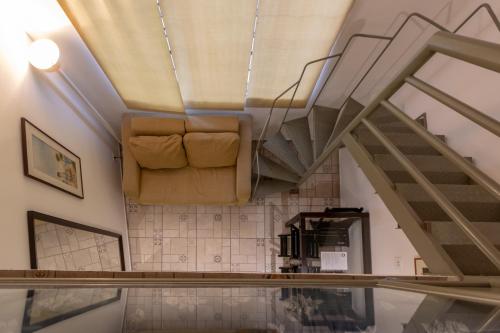 a living room with a couch and stairs at BH Studios Hotel Brás in Sao Paulo