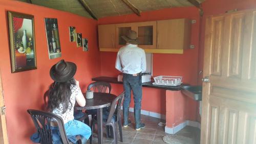 a man and a woman standing in a kitchen at Hacienda Yanahurco in Del Salitre