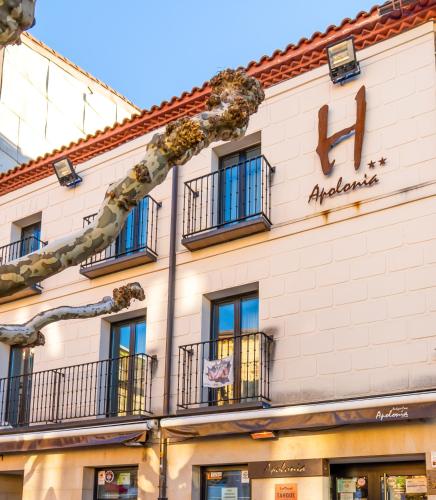 a building with a sign on the side of it at Hotel Apolonia Soria in Soria