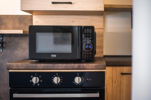 a microwave sitting on top of a stove in a kitchen at Cauriol Suites 2.3 in Cavalese