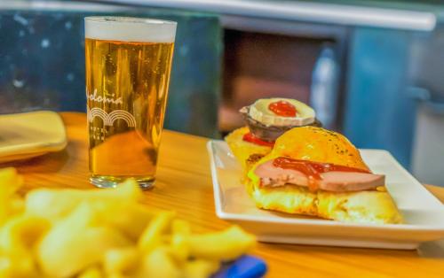 a table with a sandwich and a glass of beer at Hotel Apolonia Soria in Soria