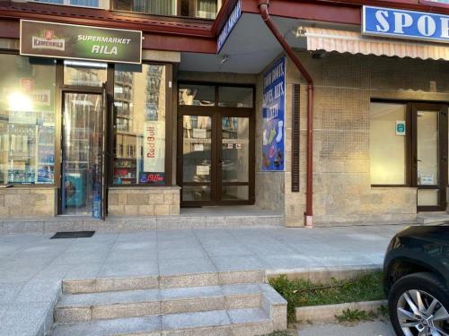 a store front of a building with a car parked in front at Lovely Аpartment in IGLIKA 2,Borovets in Borovets