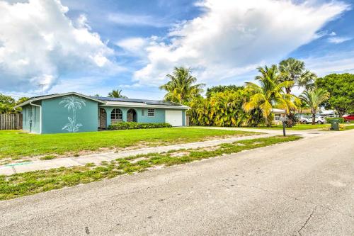 a house on the side of a road at Tropical Landing Stuart Home with Pool and Grill! in Stuart