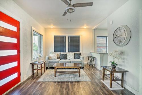a living room with a couch and a clock on the wall at Charming and Quaint El Paso House with Backyard! in El Paso