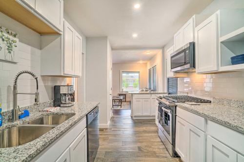 a kitchen with white cabinets and a sink at Charming and Quaint El Paso House with Backyard! in El Paso