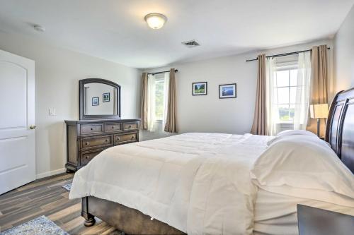 a bedroom with a bed and a mirror and a dresser at Ideally Located Glen Cove Apartment! in Glen Cove