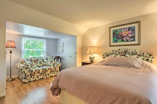 a bedroom with a bed and a chair and a window at Pet-Friendly Whitefish Bay Getaway with Large Yard! in Whitefish Bay