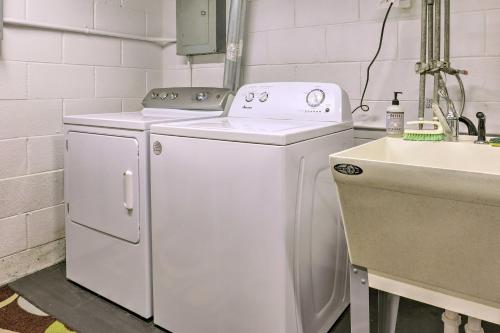 a white washer and dryer next to a sink at Pet-Friendly Whitefish Bay Getaway with Large Yard! in Whitefish Bay