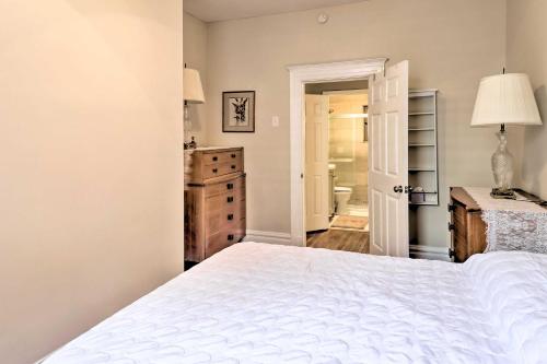 a bedroom with a white bed and a bathroom at St Louis Retreat about 1 Mi to Botanical Garden in Tower Grove
