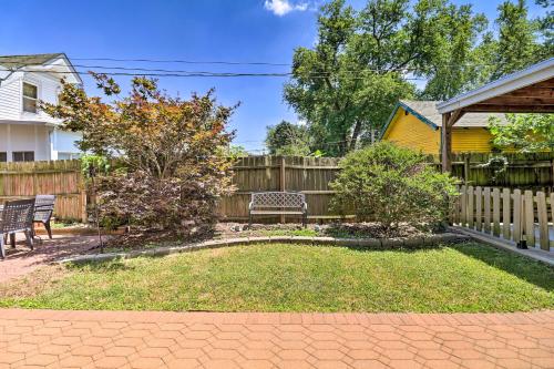 a backyard with a wooden fence and a bench at St Louis Retreat about 1 Mi to Botanical Garden in Tower Grove