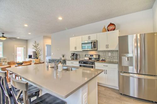 a kitchen with white cabinets and a large kitchen island at Family-Friendly Rio Rancho Home Near Old Town in Rio Rancho