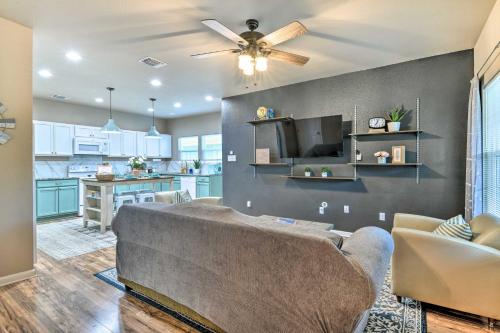 a living room with a couch and a kitchen at Charming San Antonio Home about 4 Mi to Downtown in San Antonio