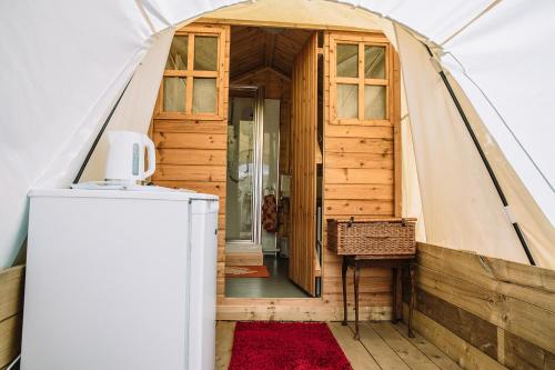 a room in a bell tent with a red rug at Appleblossom Yurt in Alkborough