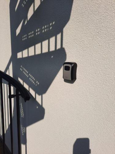 a shadow of a security camera on the side of a building at Apartmán Mikulov in Mikulov