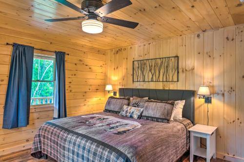 a bedroom with a bed and a ceiling fan at Wooded North Haverhill Haven with Wood Fire Pit 