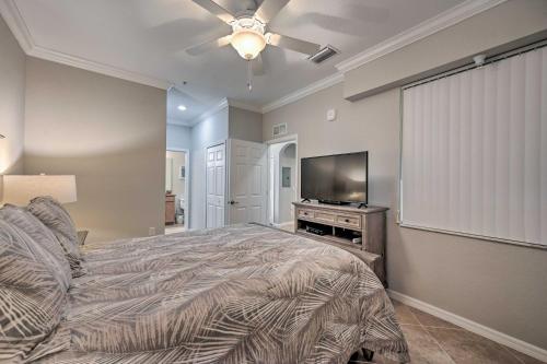a bedroom with a bed and a flat screen tv at Bonita Springs Condo with Lake and Golf Views! in Bonita Springs