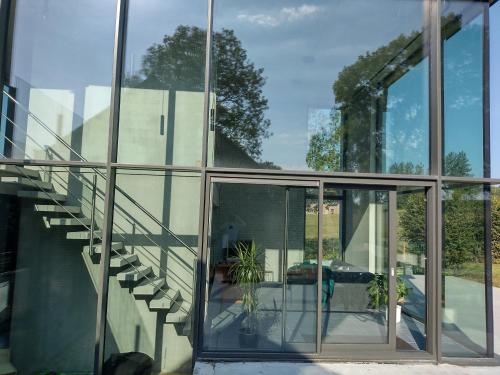 an external view of a house with glass windows at The Kettle House - Manor in Sint-Pieters-Leeuw