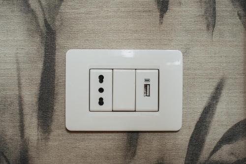 a white light switch sitting on top of a table at SUITE COLOSSEO in Rome