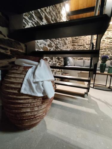 a basket sitting on a floor next to a bench at dolihis gi "loupastra"kampos ikaria in Évdhilos