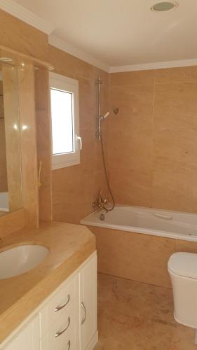 a bathroom with a sink and a tub and a toilet at Green hills in La Cala de Mijas